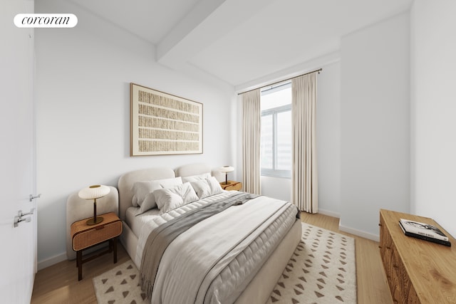 bedroom featuring light wood finished floors and baseboards