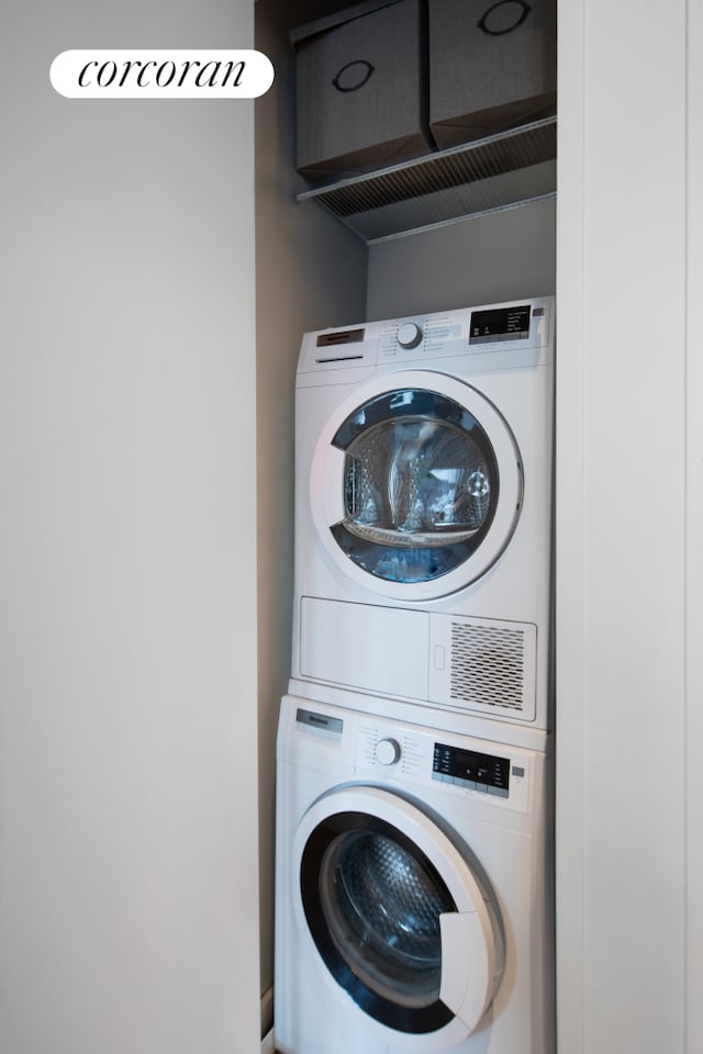 laundry area featuring stacked washer / drying machine
