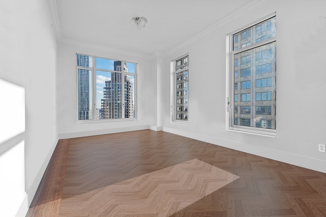empty room featuring baseboards and crown molding