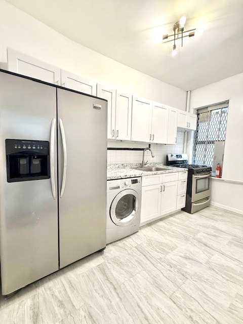 504 W 139th St Unit 14, New York City, NY 10031 - kitchen featuring appliances with stainless steel finishes, washer / clothes dryer, white cabinetry, light countertops, and decorative backsplash