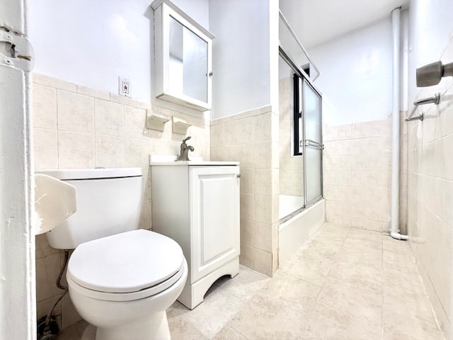504 W 139th St Unit 14, New York City, NY 10031 - full bath with tile walls, vanity, bath / shower combo with glass door, and tile patterned flooring