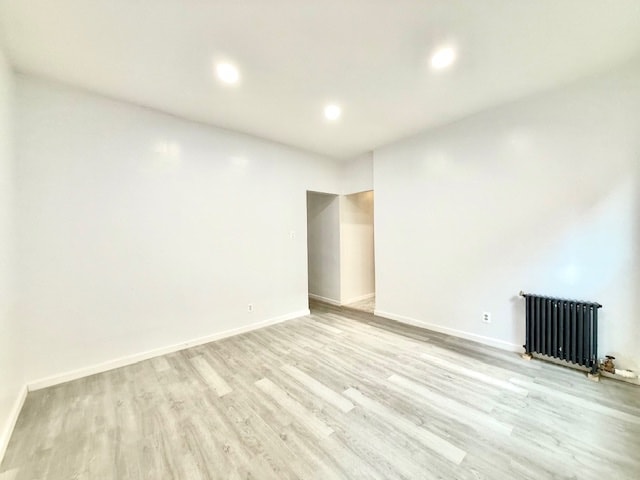 504 W 139th St Unit 14, New York City, NY 10031 - empty room featuring radiator, light wood-style floors, and recessed lighting
