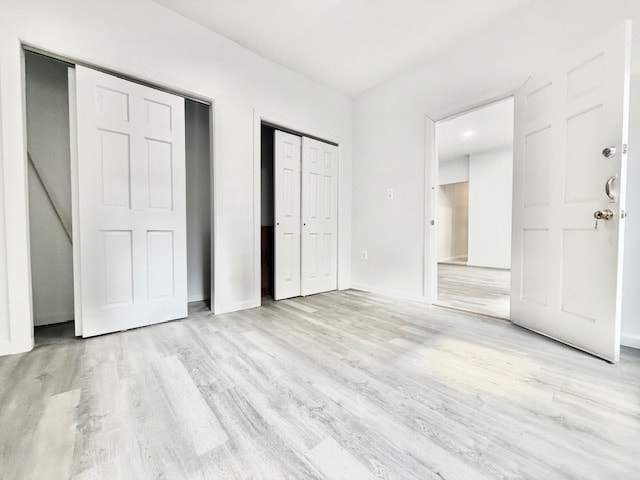 504 W 139th St Unit 14, New York City, NY 10031 - unfurnished bedroom featuring wood finished floors and two closets