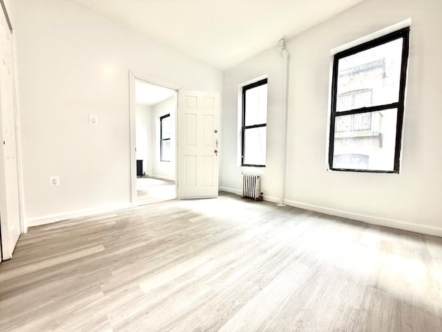 504 W 139th St Unit 14, New York City, NY 10031 - empty room with radiator heating unit and light wood finished floors