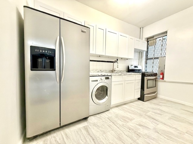 504 W 139th St Unit 14, New York City, NY 10031 - kitchen featuring stainless steel appliances, washer / clothes dryer, white cabinets, and backsplash