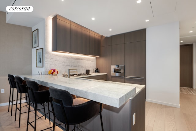 500 W 18th St Unit W9D, New York City, NY 10011 - kitchen with a peninsula, a breakfast bar, and modern cabinets