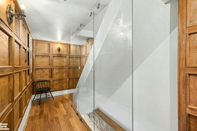 wine area with track lighting and wood finished floors