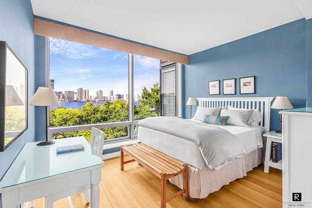2 River Ter Unit 4-J, New York City, NY 10282 - bedroom featuring wood finished floors and a skyline view