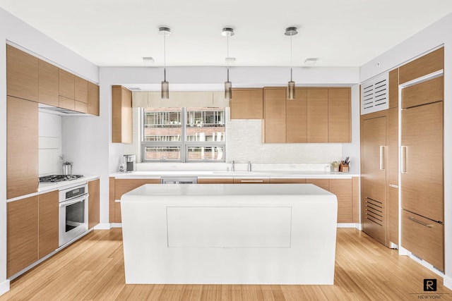 2 River Ter Unit 4-J, New York City, NY 10282 - kitchen featuring stainless steel appliances, light wood-style floors, a kitchen island, and tasteful backsplash