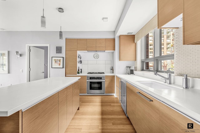 2 River Ter Unit 4-J, New York City, NY 10282 - kitchen with oven, modern cabinets, light countertops, a sink, and light wood-type flooring
