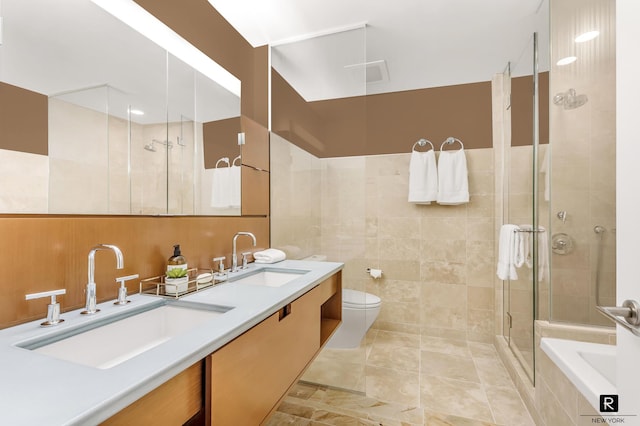 2 River Ter Unit 4-J, New York City, NY 10282 - full bathroom with a shower stall, tile walls, double vanity, a bath, and toilet