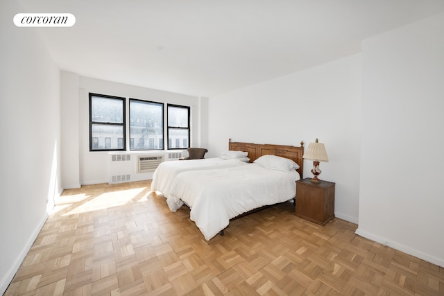 bedroom with radiator and baseboards