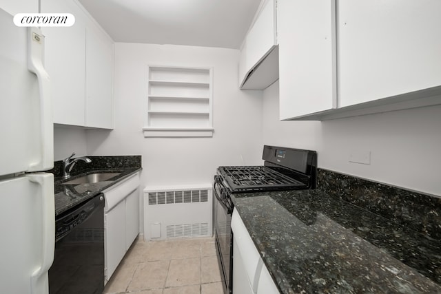 kitchen with black appliances, radiator heating unit, white cabinetry, a sink, and dark stone countertops