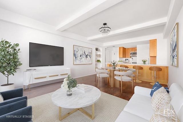 living room with wood finished floors, beam ceiling, and baseboards