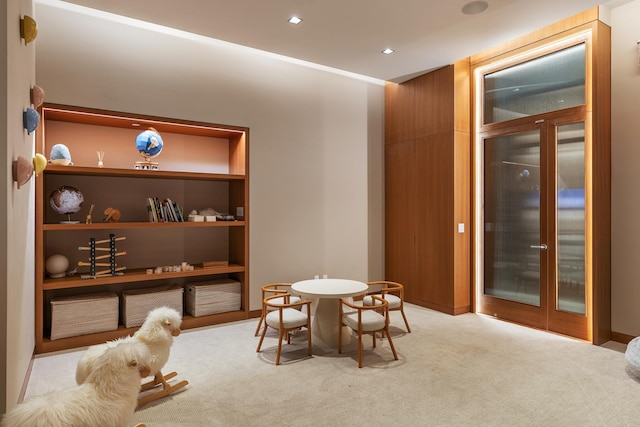 carpeted dining room with recessed lighting and built in features