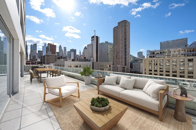 view of patio / terrace with a skyline view, an outdoor hangout area, and outdoor dining space