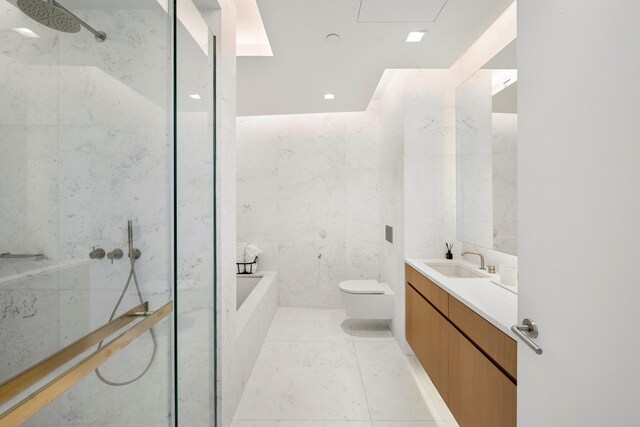 full bath with tile walls, toilet, vanity, a garden tub, and a shower