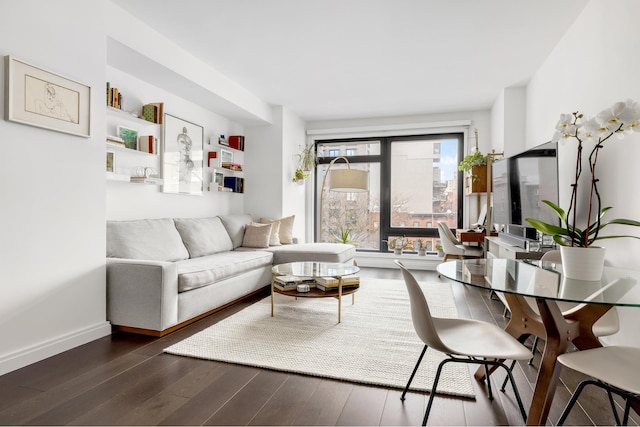 living area featuring wood finished floors and baseboards