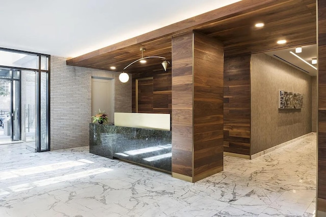 reception area with expansive windows, recessed lighting, and wooden walls