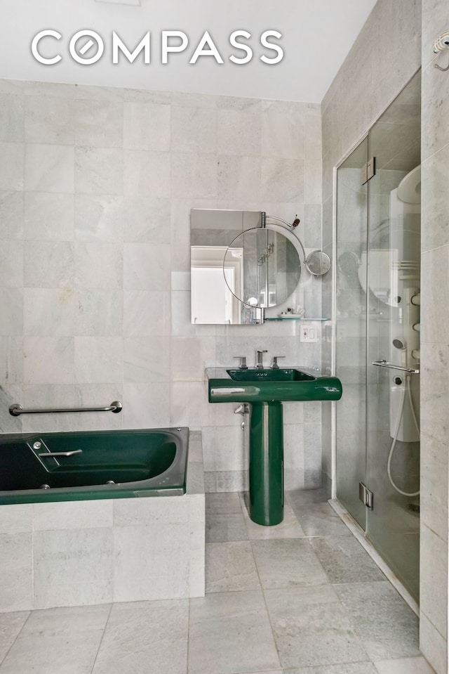 24 Monroe Pl Unit Md, New York City, NY 11201 - bathroom with a stall shower, tile walls, a bath, and tile patterned flooring