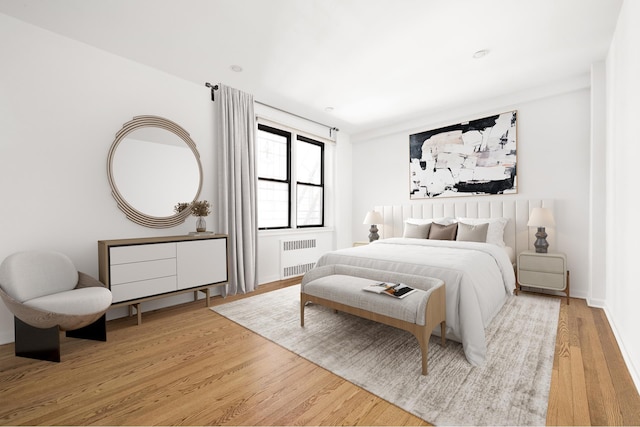 30 E 9th St Unit 5A, New York City, NY 10003 - bedroom featuring radiator and wood finished floors