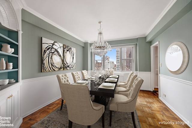 dining space with a chandelier, ornamental molding, built in shelves, and baseboards