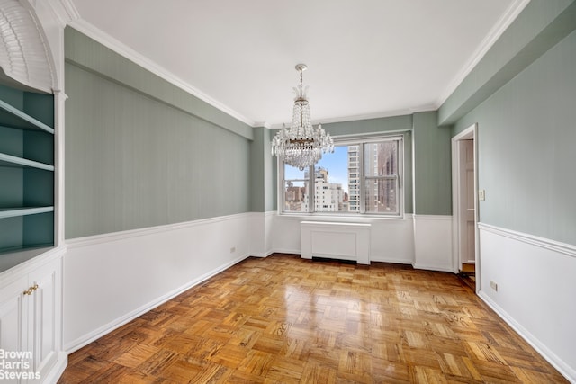 unfurnished dining area featuring a chandelier and ornamental molding