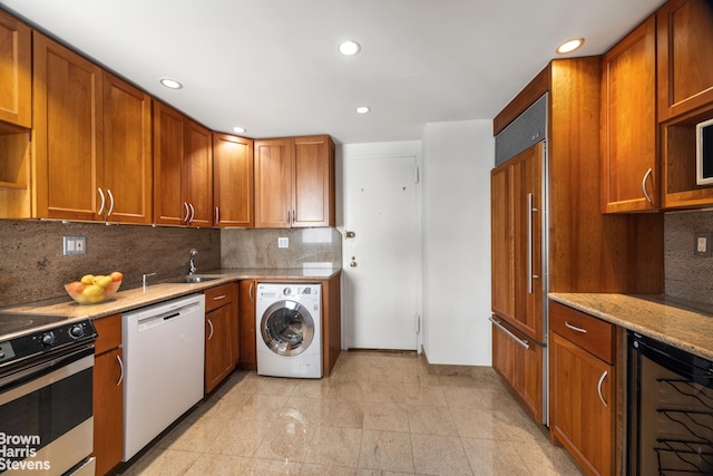 kitchen featuring washer / dryer, white dishwasher, electric stove, wine cooler, and paneled refrigerator