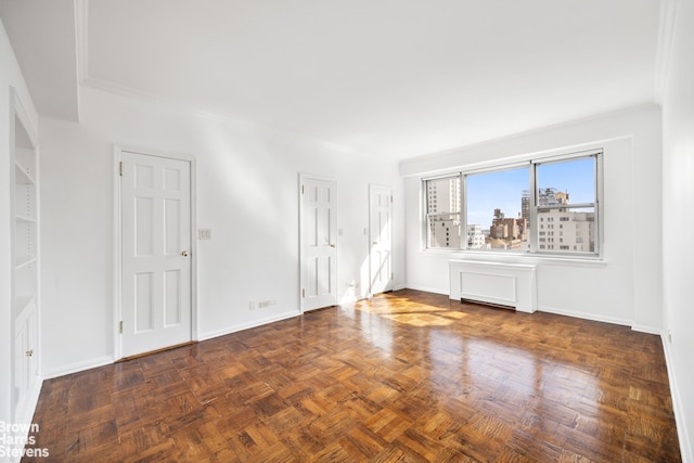 unfurnished room with baseboards and ornamental molding