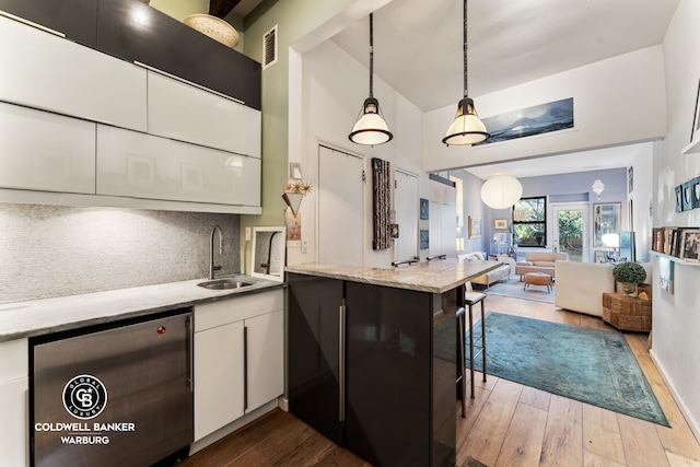 240 E 32nd St Unit 1A, New York City, NY 10016 - kitchen featuring a sink, refrigerator, hardwood / wood-style flooring, tasteful backsplash, and white cabinets