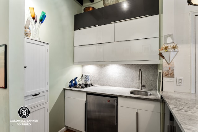 240 E 32nd St Unit 1A, New York City, NY 10016 - kitchen with refrigerator, a sink, tasteful backsplash, white cabinetry, and light stone countertops