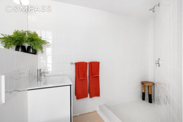 272 Greene Ave, New York City, NY 11238 - bathroom with tile walls, vanity, and tiled shower
