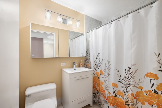 bathroom featuring toilet, vanity, and a shower with shower curtain