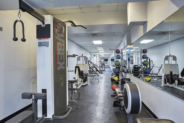 gym featuring a paneled ceiling and visible vents