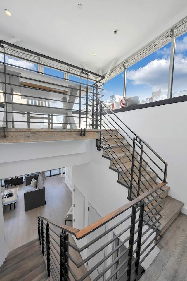stairs featuring wood finished floors
