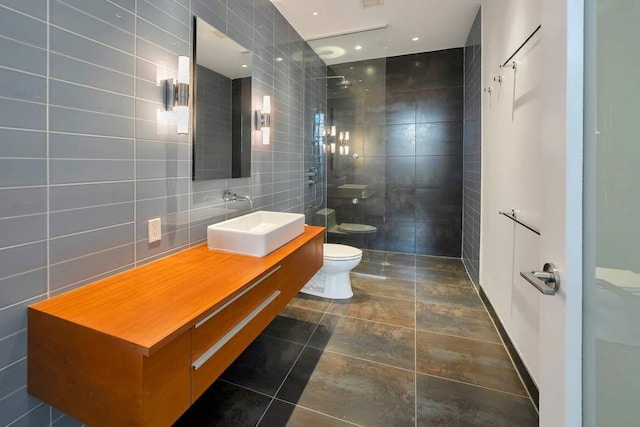 full bathroom featuring walk in shower, vanity, toilet, tile patterned floors, and tile walls