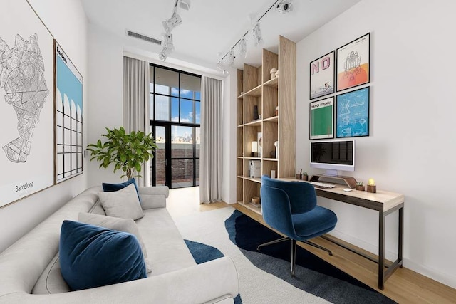 office area featuring visible vents, rail lighting, and built in desk