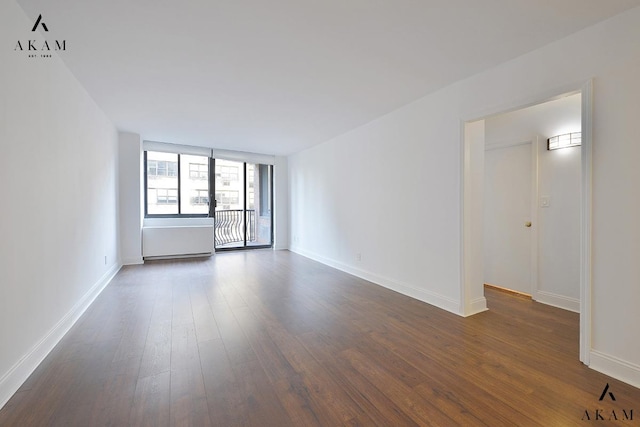 343 E 74th St Unit 7-J, New York City, NY 10021 - unfurnished room featuring dark wood-style flooring and baseboards