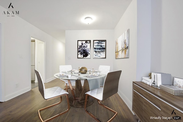 343 E 74th St Unit 7-J, New York City, NY 10021 - dining area with baseboards and dark wood-style flooring