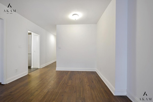 343 E 74th St Unit 7-J, New York City, NY 10021 - spare room with baseboards and dark wood-style floors
