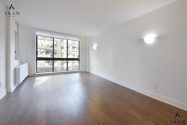 343 E 74th St Unit 7-J, New York City, NY 10021 - unfurnished room featuring dark wood-style floors and baseboards