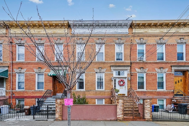 64-07 68th Ave, New York City, NY 11385 - multi unit property with brick siding and a fenced front yard