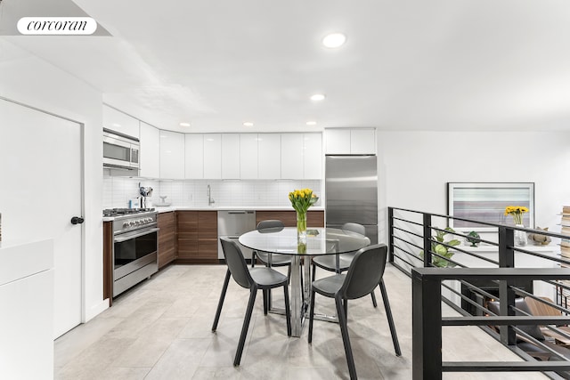 322 W 22nd St Unit 2, New York City, NY 10011 - kitchen featuring modern cabinets, stainless steel appliances, white cabinets, tasteful backsplash, and recessed lighting
