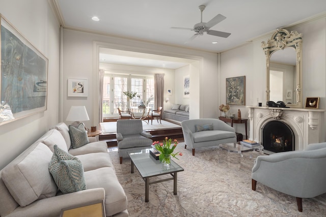 living room with a ceiling fan, a warm lit fireplace, recessed lighting, and crown molding