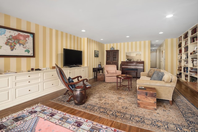 living room with recessed lighting, wallpapered walls, and dark wood-style flooring