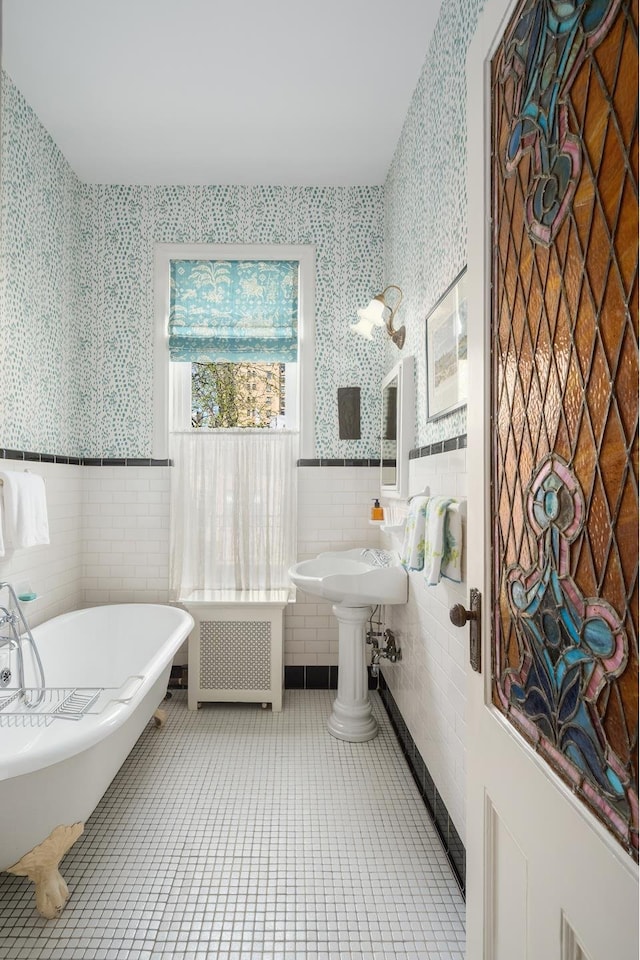 full bathroom featuring radiator, wallpapered walls, and tile walls