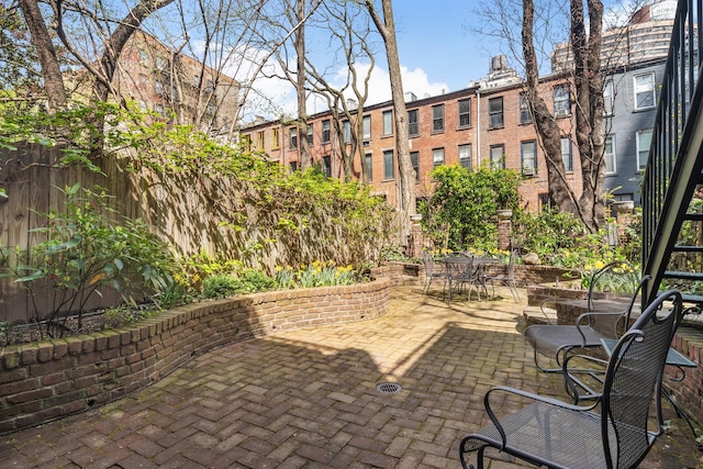 view of patio featuring fence and outdoor dining space