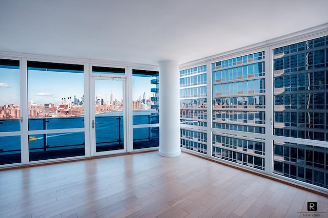 22 N 6th St Unit 20-D, New York City, NY 11249 - spare room featuring a city view, floor to ceiling windows, and wood finished floors