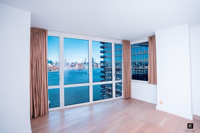 22 N 6th St Unit 20-D, New York City, NY 11249 - empty room with a view of skyline and wood finished floors