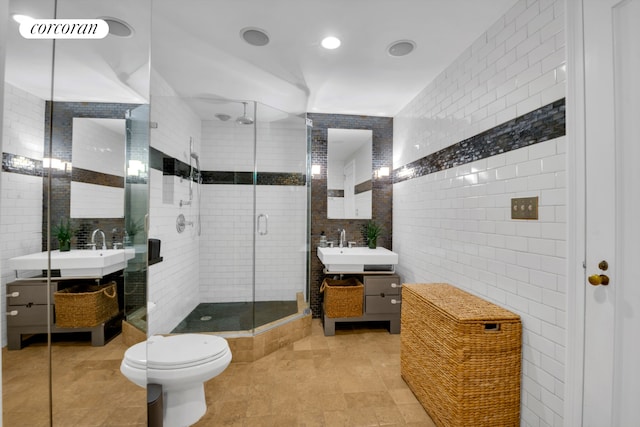 201 W 16th St Unit 12Dg, New York City, NY 10011 - full bathroom featuring tile walls, a stall shower, two vanities, and tile patterned floors